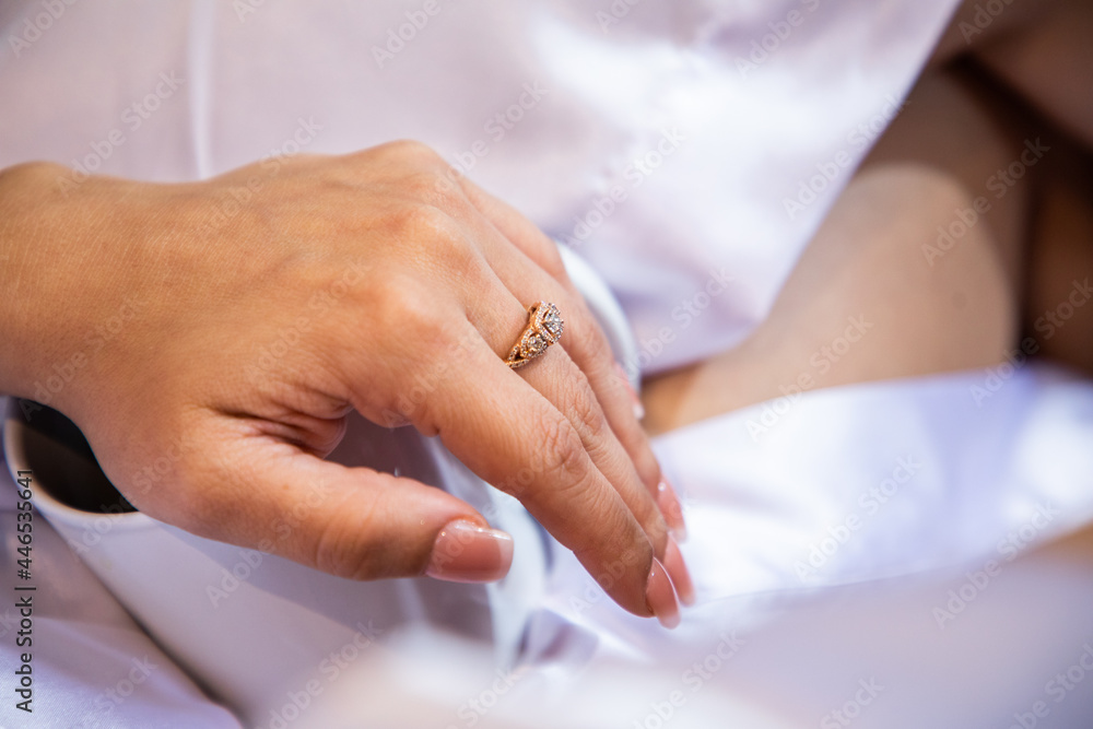Close up of an elegant engagement diamond ring on woman finger. Close up of an elegant engagement diamond ring on woman finger.