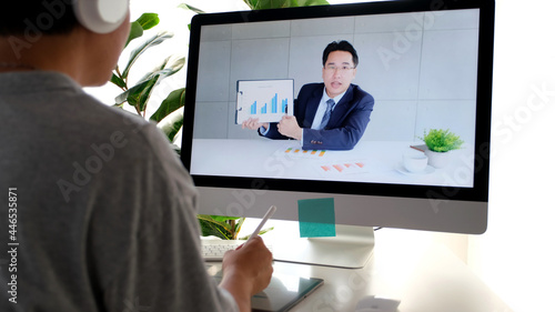 Video conference, Work from home, Asian man holding business chart while making video call to business team with virtual web, Contacting colleague by conference on computer at home