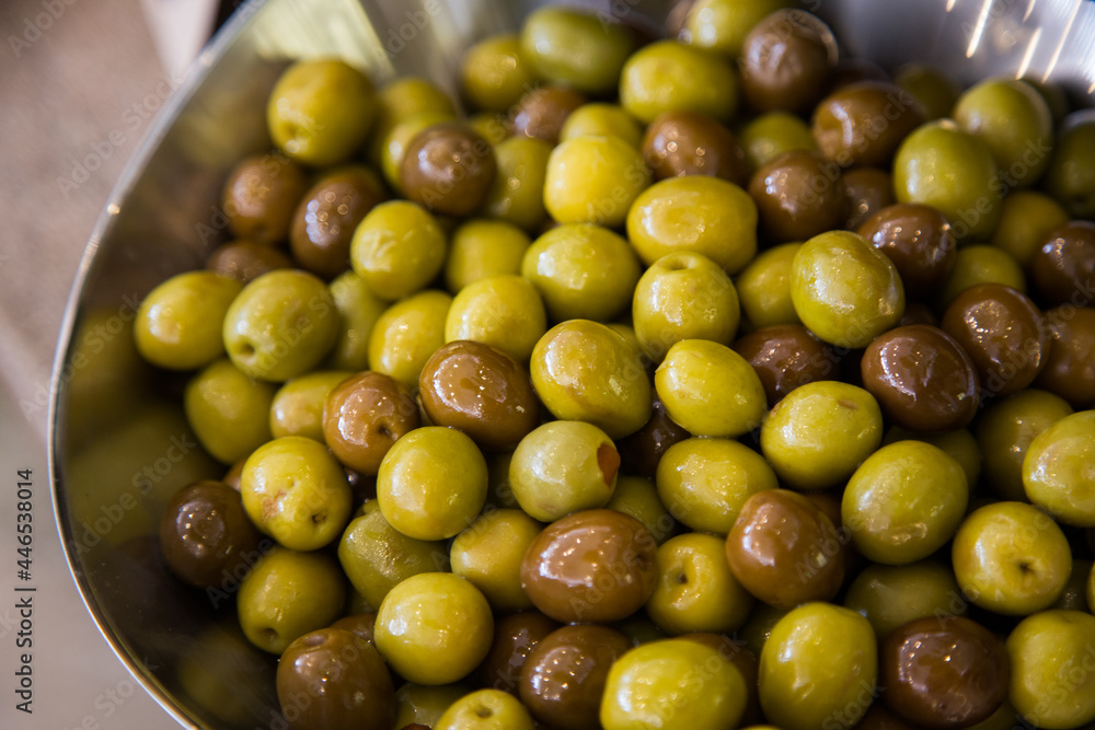 Different marinated olives on a silver bowl. Different marinated olives on a silver bowl.