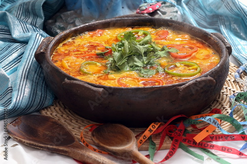 Fish moqueca, a classic dish of Bahian cuisine, served in a clay pot photo