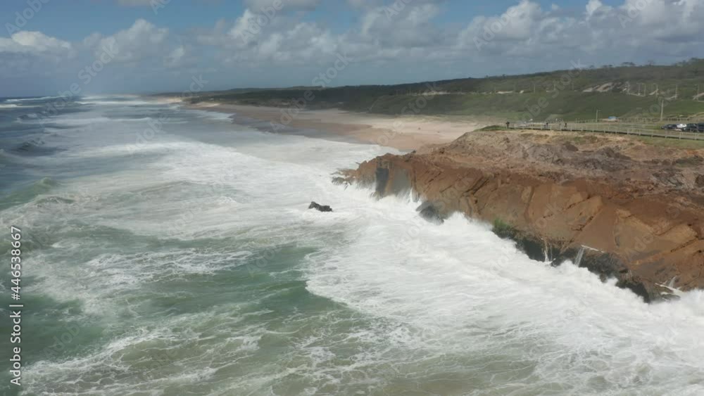 Aerial overview of waves slamming into cliff Aerial overview of waves slamming into cliff