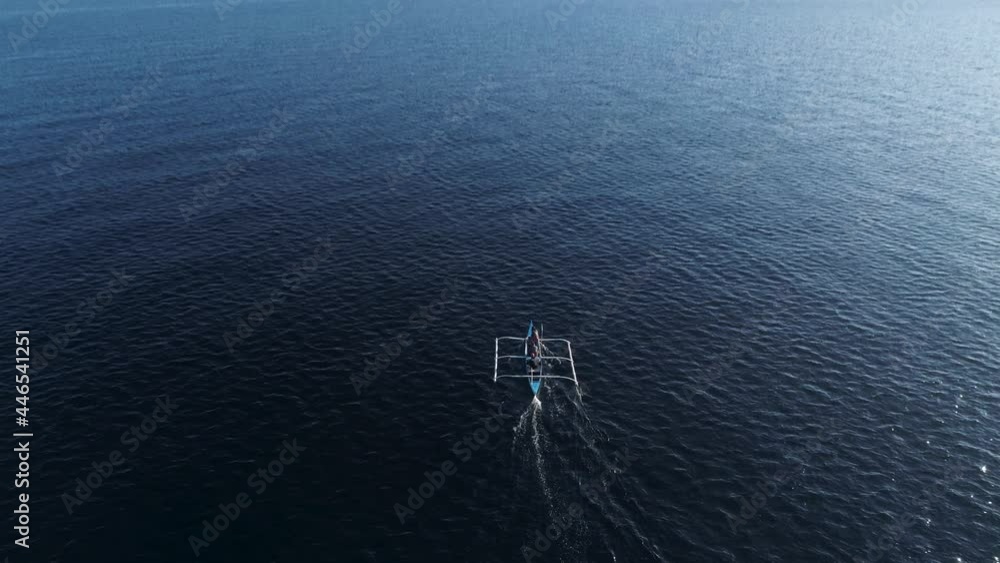 Above traditional Philippines outrigger boat going to fishing grounds off shore Above traditional Philippines outrigger boat going to fishing grounds off shore