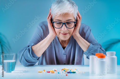 Senior patient failing to follow medical advice, demonstrating prescribed medicine non-adherence behavior.