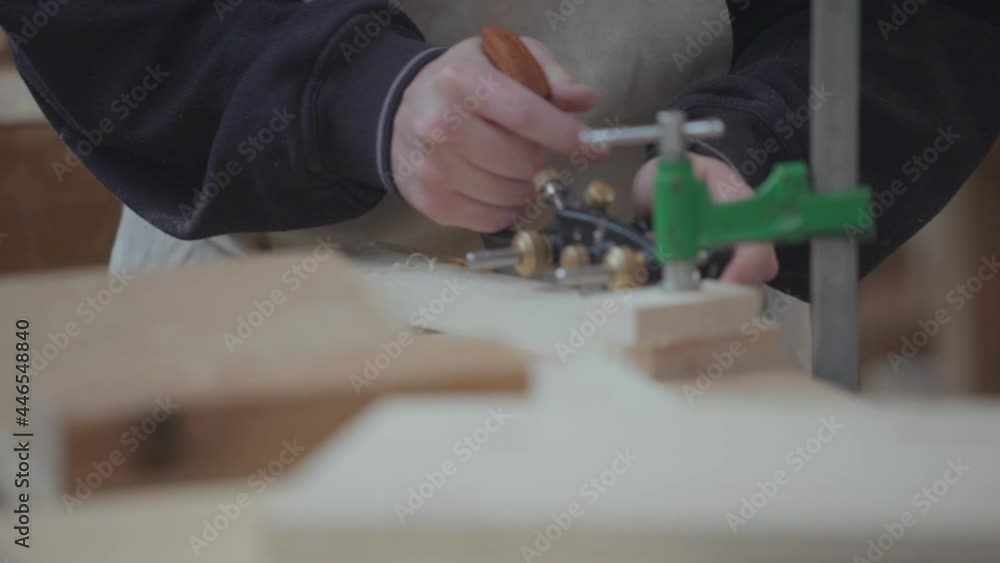 Focus on the carpenter's hand working a piece of wood with Veritas plough.
Static view. Focus on the carpenter's hand working a piece of wood with Veritas plough.
Static view.