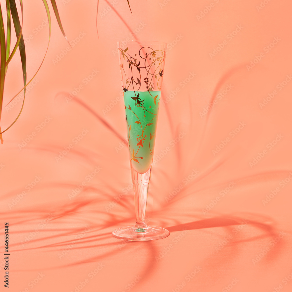 Obraz premium A unique glass with cocktail summer shade warm terracotta background. Afterparty chill vibe around.