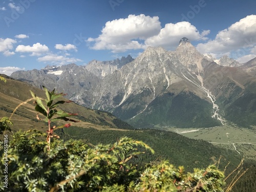 Svaneti, Georgia in September: high mountains covered with snow with green scenery
