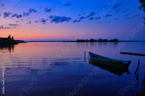 Sunset reflection on Lake Seliger with a boat photo