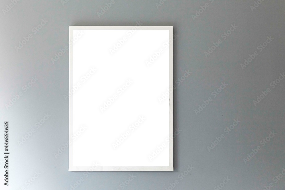 Blank white photo frame on a smooth gray wall Blank white photo frame on a smooth gray wall