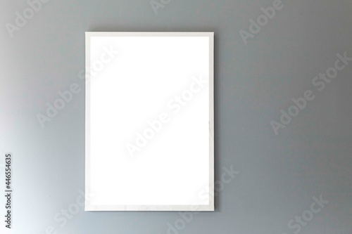 Blank white photo frame on a smooth gray wall