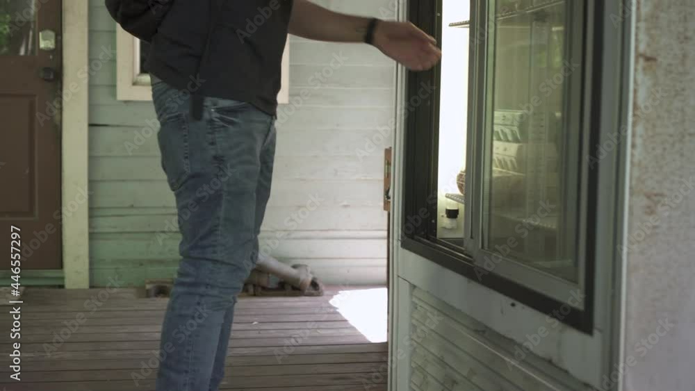 Man picking up fresh eggs from the fridge of a farm. Man picking up fresh eggs from the fridge of a farm.
