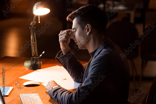 Tired businessman working i...