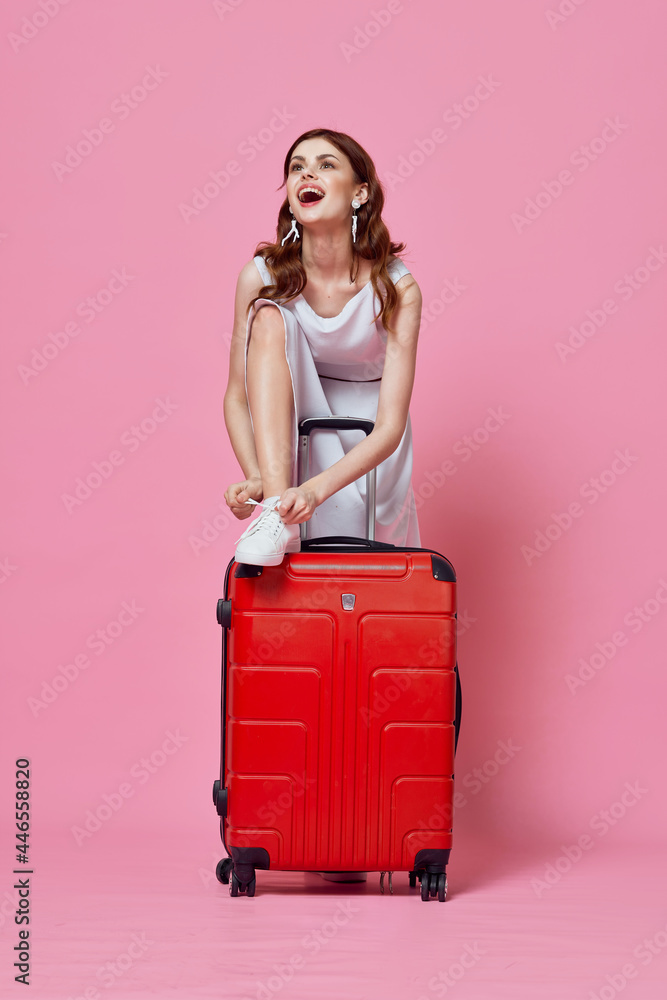 woman tourists in white dress with red suitcase lifestyle passenger pink background woman tourists in white dress with red suitcase lifestyle passenger pink background