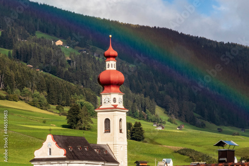 Rainbow over the church at Villabassa. Dolomite Italy. photo
