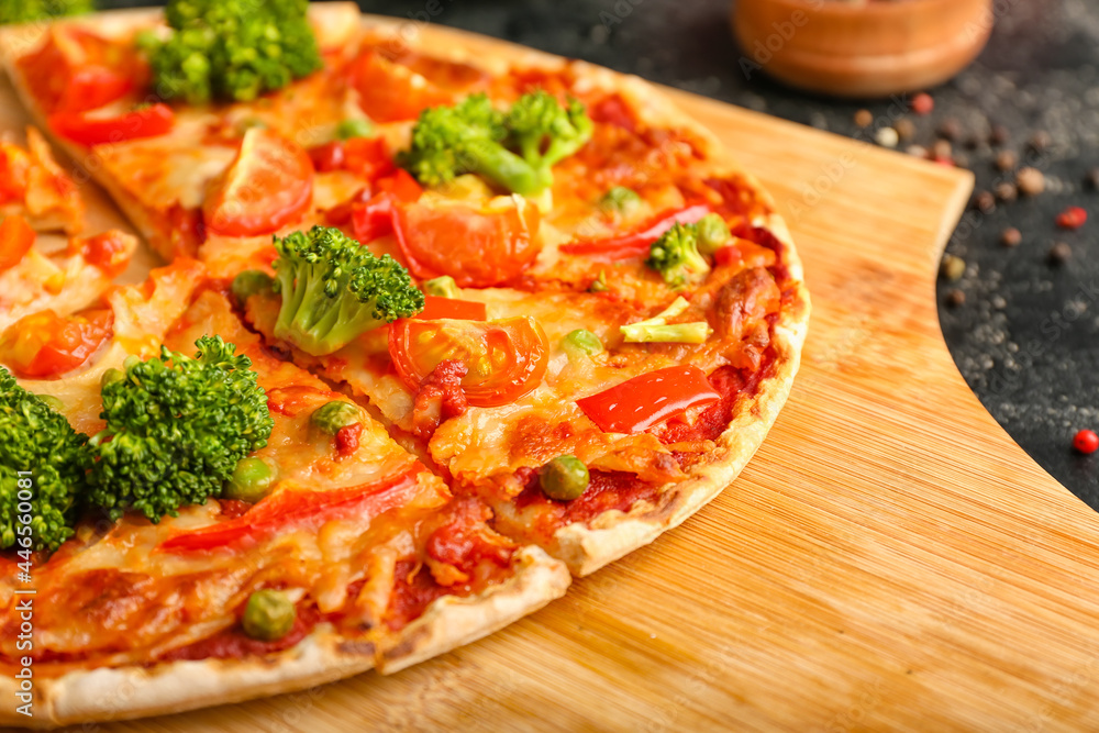 Board with tasty vegetarian pizza on dark background, closeup Board with tasty vegetarian pizza on dark background, closeup
