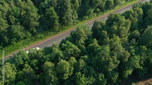 The sun's rays illuminate the white truck that is moving into the suburbs. Delivery of goods to the consumer, transportation of goods over medium distances. High quality. 4k footage.