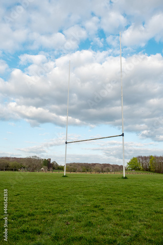 Tall goal posts for Irish national sports, camogie, hurling, Gaelic football, soccer and rugby. Warm sunny day. Blue cloudy sky. Vertical image