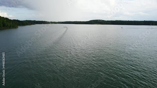 Aerial view of Lake with shiny water and green trees. Sun reflection in the water. Beautiful spring landscape with open water photo