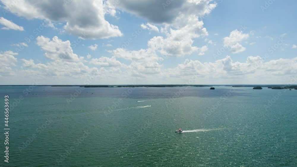 Aerial view of Lake with shiny water and green trees. Sun reflection in the water. Beautiful spring landscape with open water Aerial view of Lake with shiny water and green trees. Sun reflection in the water. Beautiful spring landscape with open water