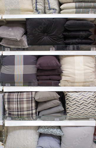 Cool gray scale cushions and bed wear on shelves