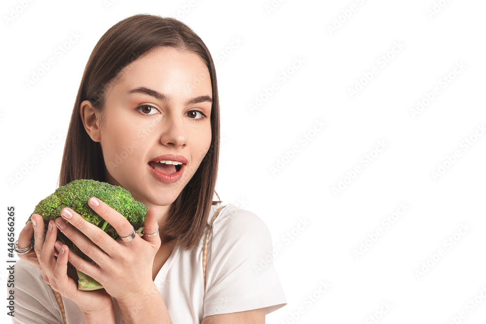 Surprised young woman with fresh broccoli on white background Surprised young woman with fresh broccoli on white background