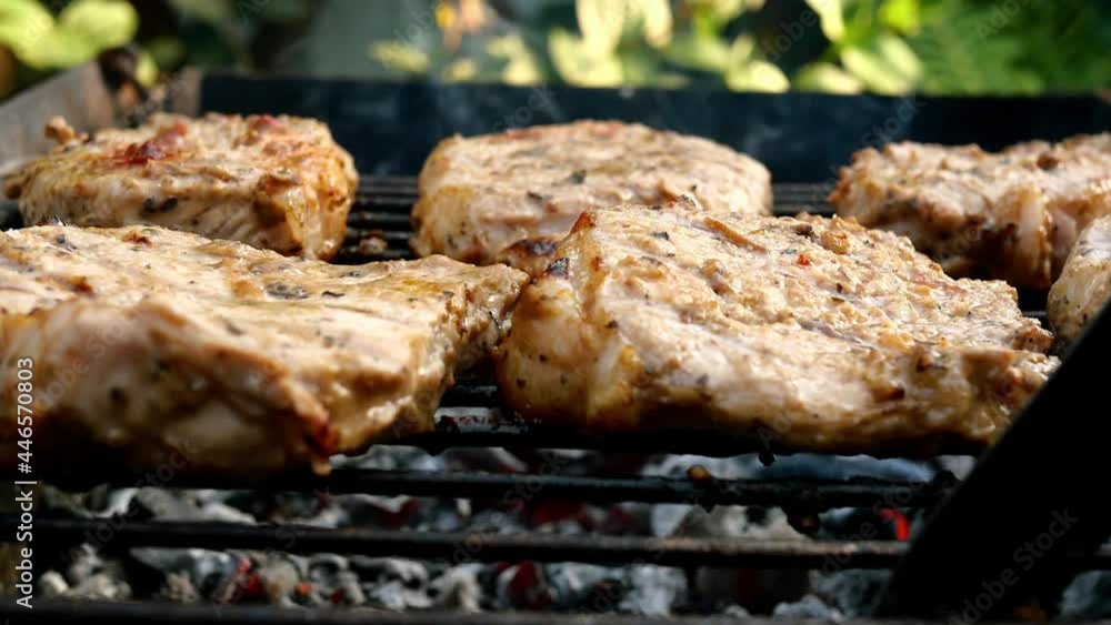 Frying juicy pieces of fresh pork neck steak meat prepared on grill or outdoor barbecue lattice on nature in backyard. Smoke on charcoal. Close-up. Frying juicy pieces of fresh pork neck steak meat prepared on grill or outdoor barbecue lattice on nature in backyard. Smoke on charcoal. Close-up.