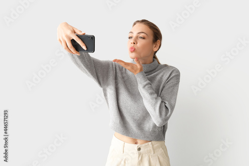 Young woman taking selfie o...