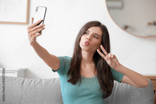 Beautiful young woman takin...