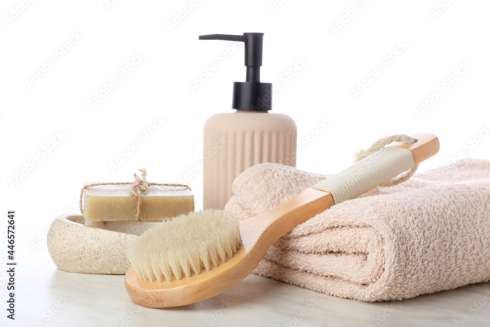 Massage brush and different bath supplies on white background Massage brush and different bath supplies on white background