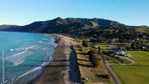 Birds eye view of amazing sandy beach, calm blue ocean, hills on horizon. Tokomaru Bay, New Zealand, landscape photo