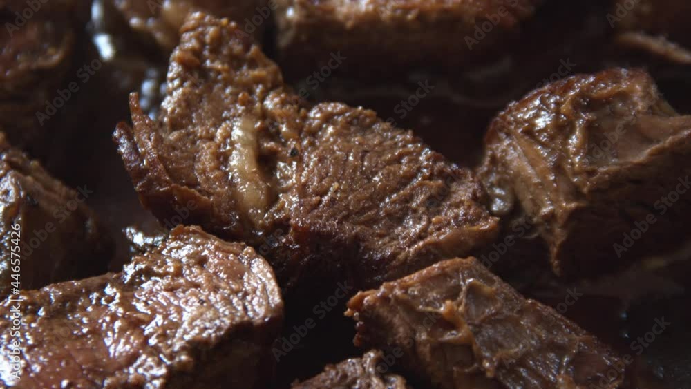 Close up of chunks of steak being cooked in a pan. Close up of chunks of steak being cooked in a pan.