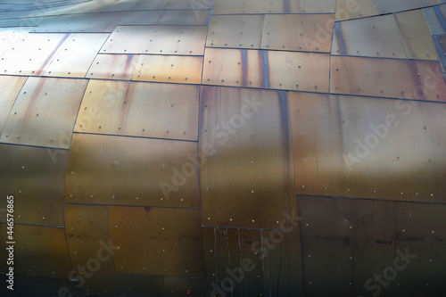 Copper metal plates with rivets and water stains. Muliti color metal background abstract metal patina photo