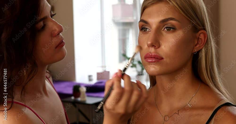 Process of making makeup. Make-up artist working with brush on model woman face. Process of making makeup. Make-up artist working with brush on model woman face.