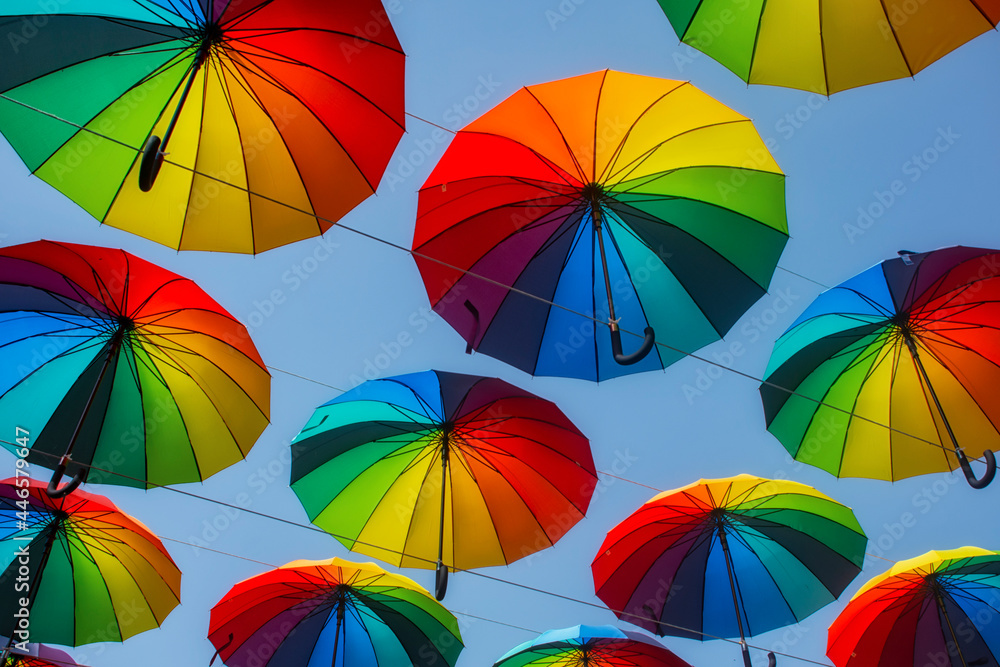 Rainbow multi-colored umbrellas from the rain on the background of the sky.