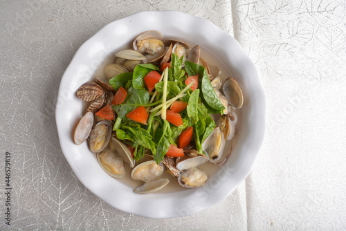 stir fried fresh Lala clam shell seafood with spinach vegetables asian halal menu photo
