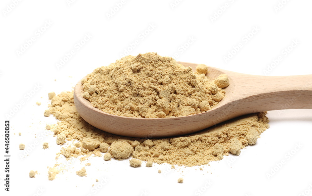 Ginger powder pile with wooden spoon isolated on white background Ginger powder pile with wooden spoon isolated on white background