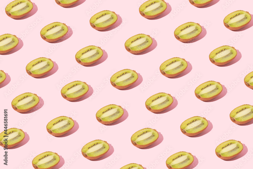 Fresh kiwi slices pattern on pink background. Tropical fruit creative wallpaper. Summer food minimal concept. Flat lay. Top view. Fresh kiwi slices pattern on pink background. Tropical fruit creative wallpaper. Summer food minimal concept. Flat lay. Top view.