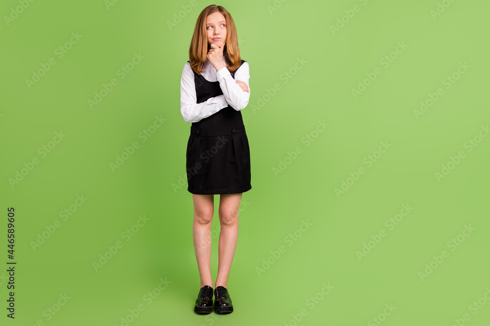 Full length body size view of attractive minded girl overthinking copy space isolated over green color background Full length body size view of attractive minded girl overthinking copy space isolated over green color background