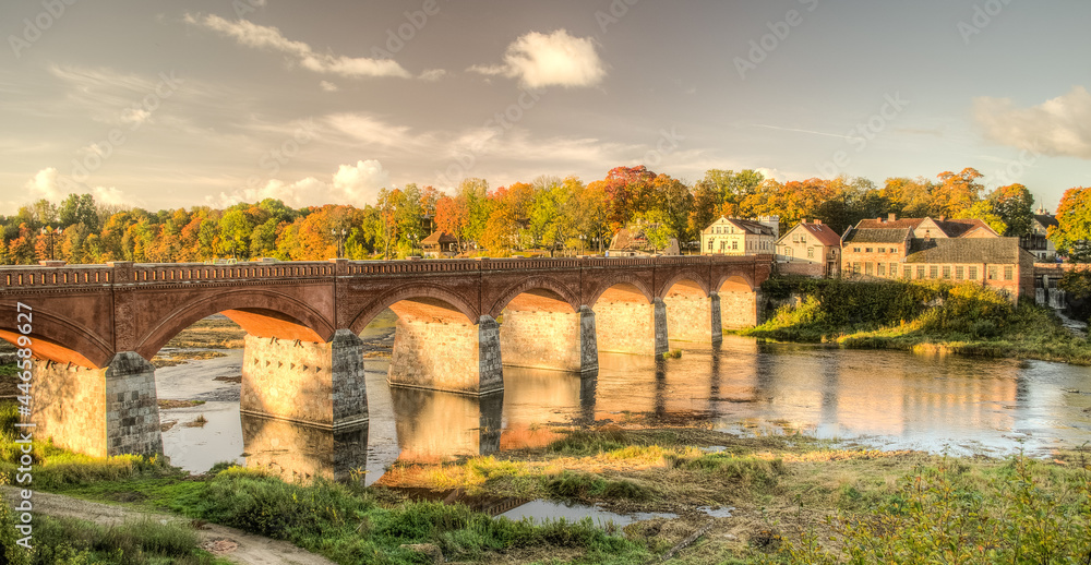 Obraz premium Long brick bridge in sunny autumn day, Kuldiga, Latvia.
