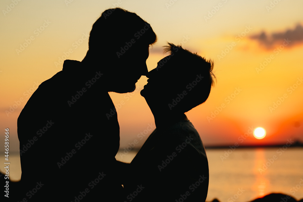 silhouette of loving couple on sunset on beach