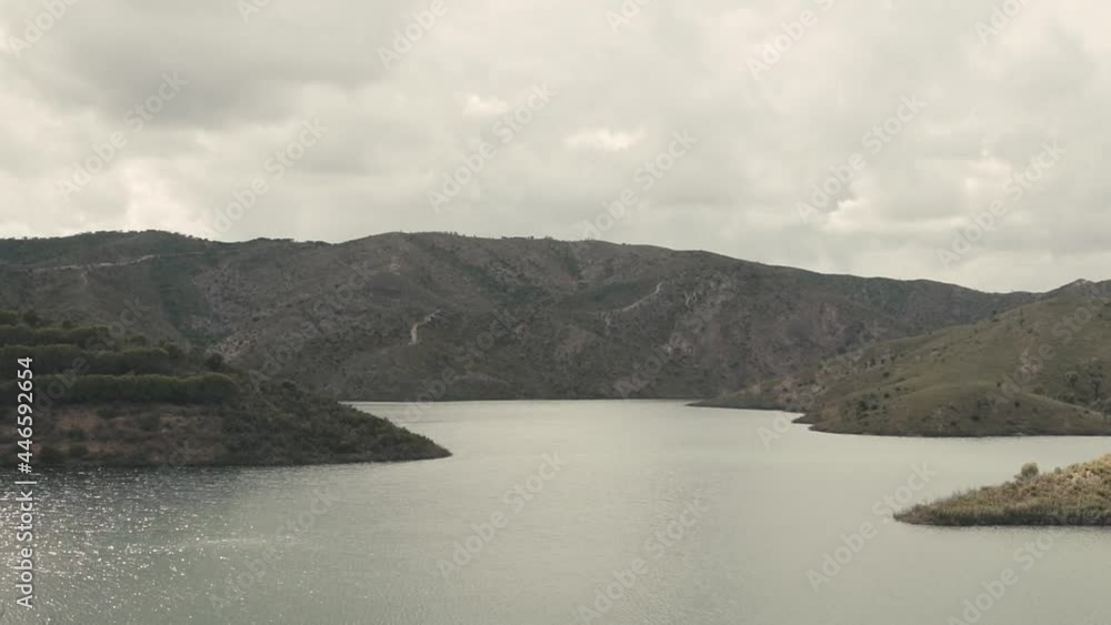Aerial wide shot of tranquil portuguese lake during cloudy day after sunset. Beautiful landscape with tranquil lake in Portugal. Aerial wide shot of tranquil portuguese lake during cloudy day after sunset. Beautiful landscape with tranquil lake in Portugal.