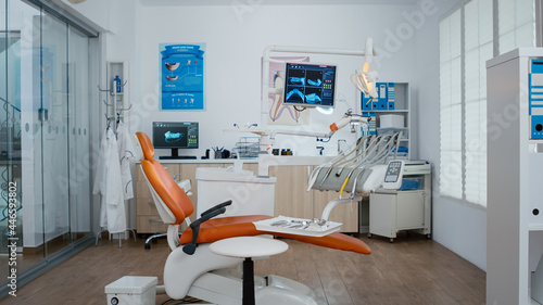 Empty dental orthodontic stomatology office with nobody in. Bright modern equipped orthodontic workplace, oral hygiene and care. Hospital dental health. Wide to zoom in shoot