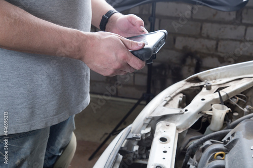 A scanner for car diagnostics.Auto electrician.Repair of electrical equipment of the car.Diagnostics of the car.