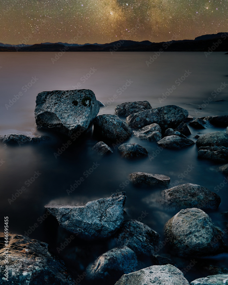 Long exposure photo with a starry night sky, shot in Norway. The rocks are magical. 