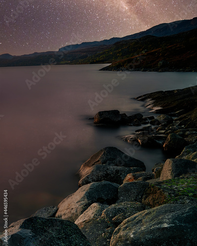 Fototapeta Naklejka Na Ścianę i Meble -  Long exposure photo with a starry night sky, shot in Norway. The rocks are magical. 