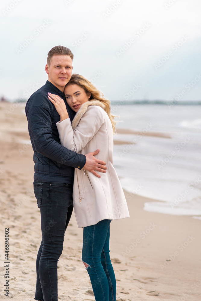 Two Young couple standing enjoying on a coast and enjoying each other.Summer,spring,autumn vacation. Two Young couple standing enjoying on a coast and enjoying each other.Summer,spring,autumn vacation.