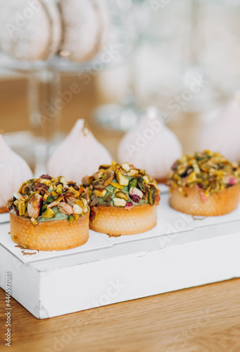 Candy bar. Beautiful multi colored decorated candy table baked sweet tasty cupcake cupcakes on a party. Beautifully decorated catering banquet table with different candy sweet delicacy.