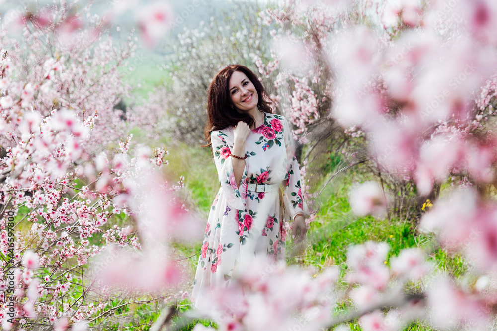 beautiful woman in a dress in the garden of flowering trees in the spring beautiful woman in a dress in the garden of flowering trees in the spring