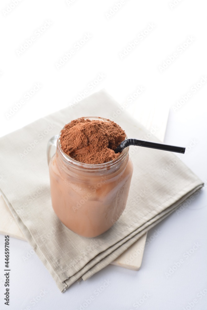 cold iced chocolate milo dinosaur with coco powder in glass jar white background asian beverage halal menu cold iced chocolate milo dinosaur with coco powder in glass jar white background asian beverage halal menu