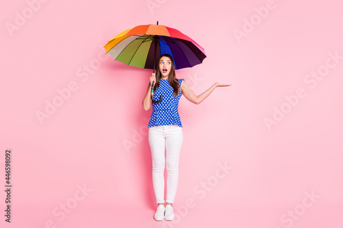 Full length photo of young excited woman amazed surprised weather rainy parasol isolated over pastel color background