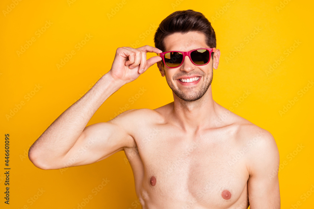 Photo of funky attractive young guy shirtless dressed dark glasses smiling isolated yellow color background
